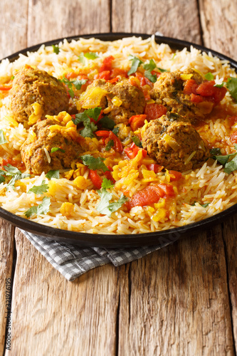 Kofta challow is a traditional Afghan dish consisting of meatballs and white rice close-up in a plate. Vertical photo