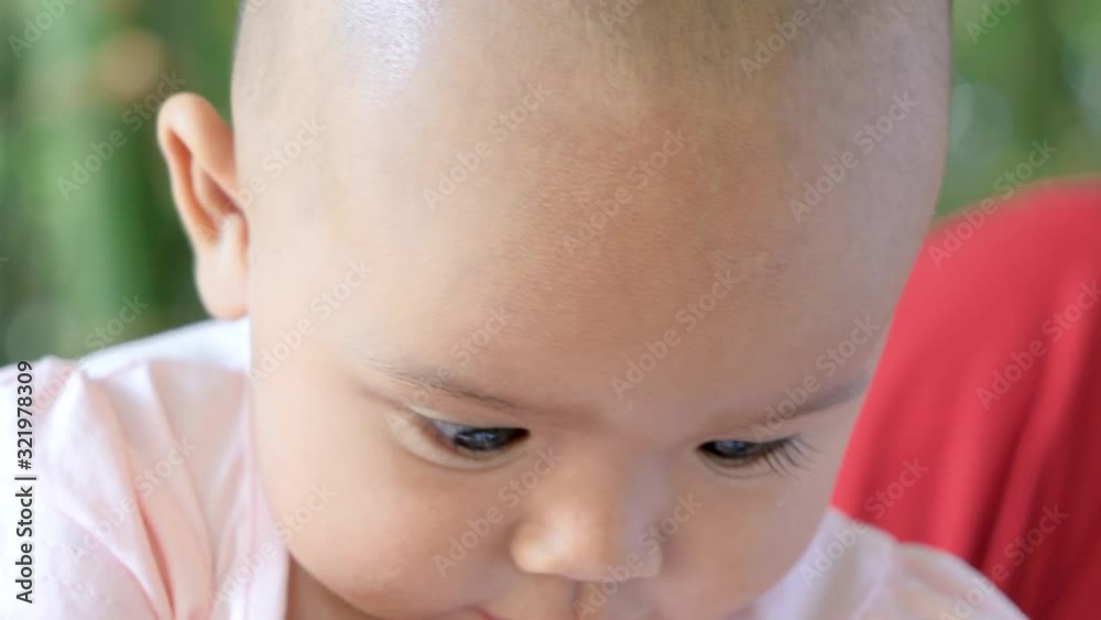 Cute little Asian baby sitting and play with happiness Cute little Asian baby sitting and play with happiness
