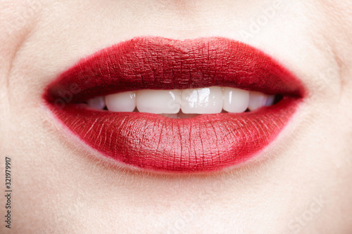 Closeup macro portrait of female red smiling lips with day beauty makeup.