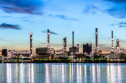 Foto Oil and gas refinery industry plant with glitter lighting and sunrise in the morning, Factory of petroleum industrial, Power plant,Energy power station area