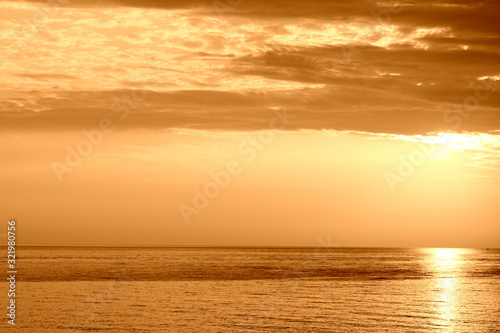 Beautiful sunrise over the sea near the coast of Sicily. Natural background orange color toned © Talulla