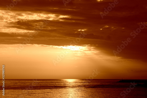 Beautiful sunrise over the sea near the coast of Sicily. Natural background orange color toned