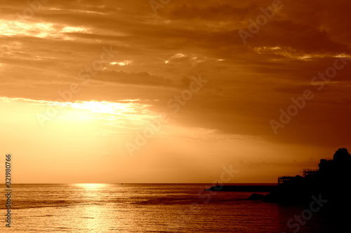 Beautiful sunrise over the sea near the coast of Sicily. Natural background orange color toned