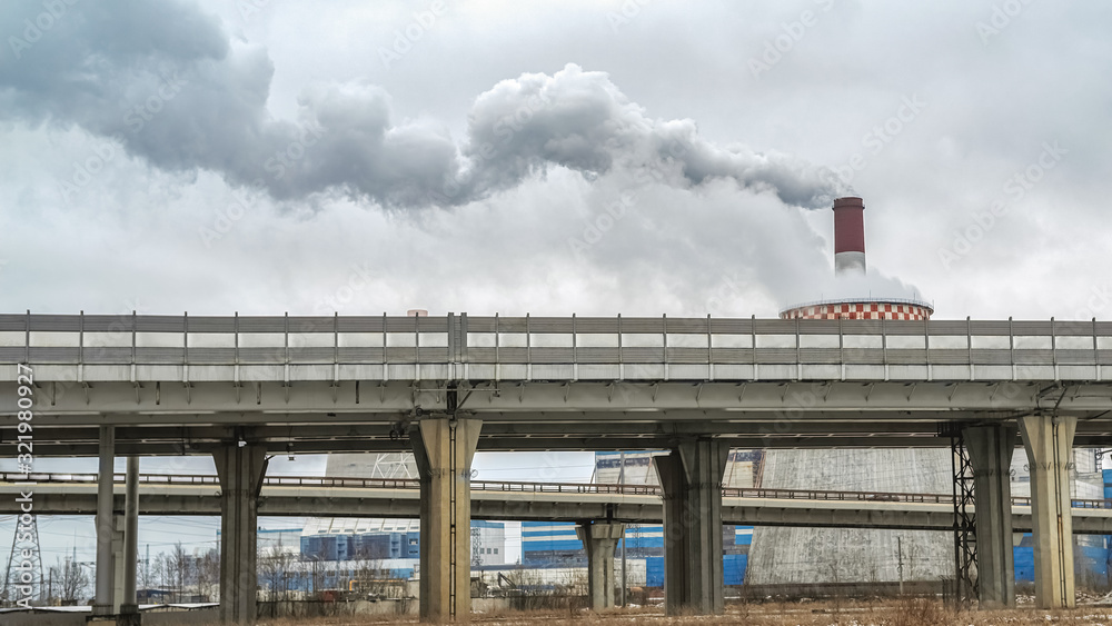 Concrete pillars of the viaduct and the Smoking chimneys of large enterprises. The concept of urbanization.