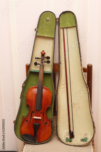 Broken antique red violin for restoration with damage