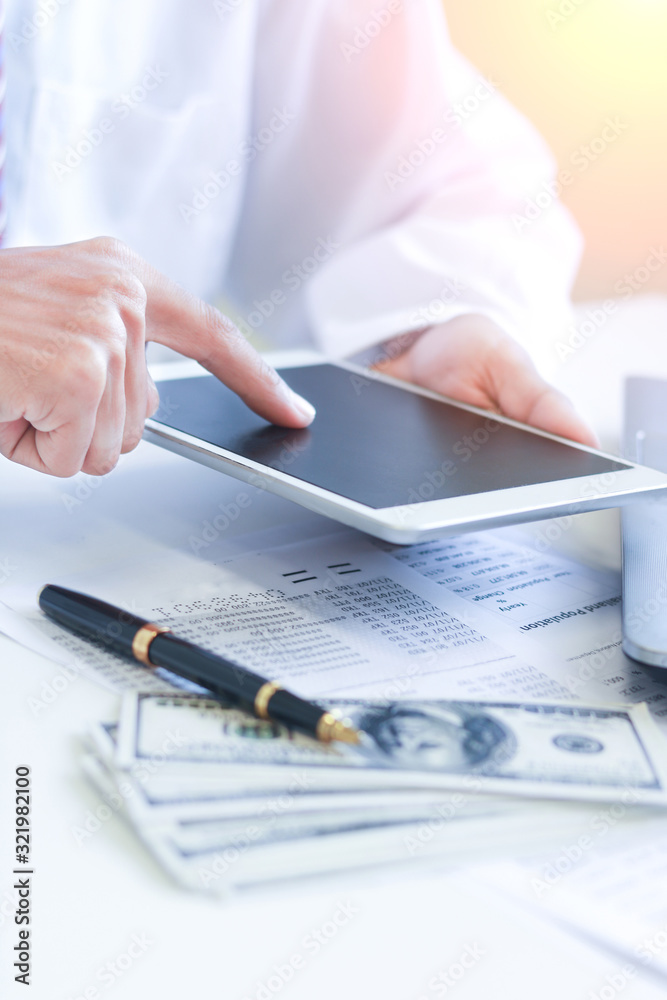 Fototapeta premium Businessman with cash dollars - business concept,tablet and finance,investment,save.