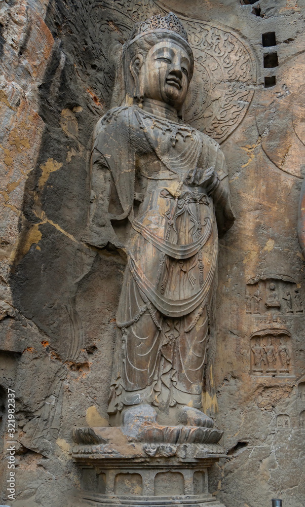 Big statue made in limestone of bodhisattvas. The main cave (Fengxiangsi Cave) of Longmen Grottoes in Luoyang . A world heritage Site in Henan province, China. 