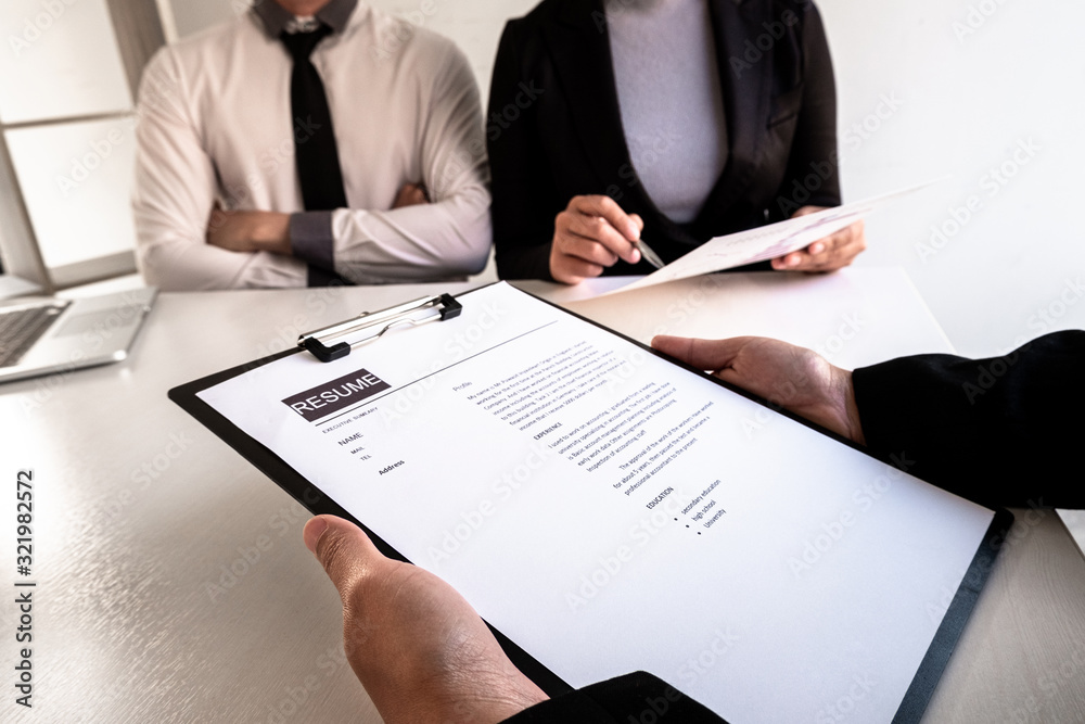 Company managers hold a resume, interviewing job applicants in large companies, business concepts, careers and recruitment Company managers hold a resume, interviewing job applicants in large companies, business concepts, careers and recruitment