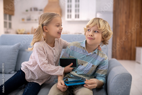 Girl trying to embrase boy, boy feeling surprised photo