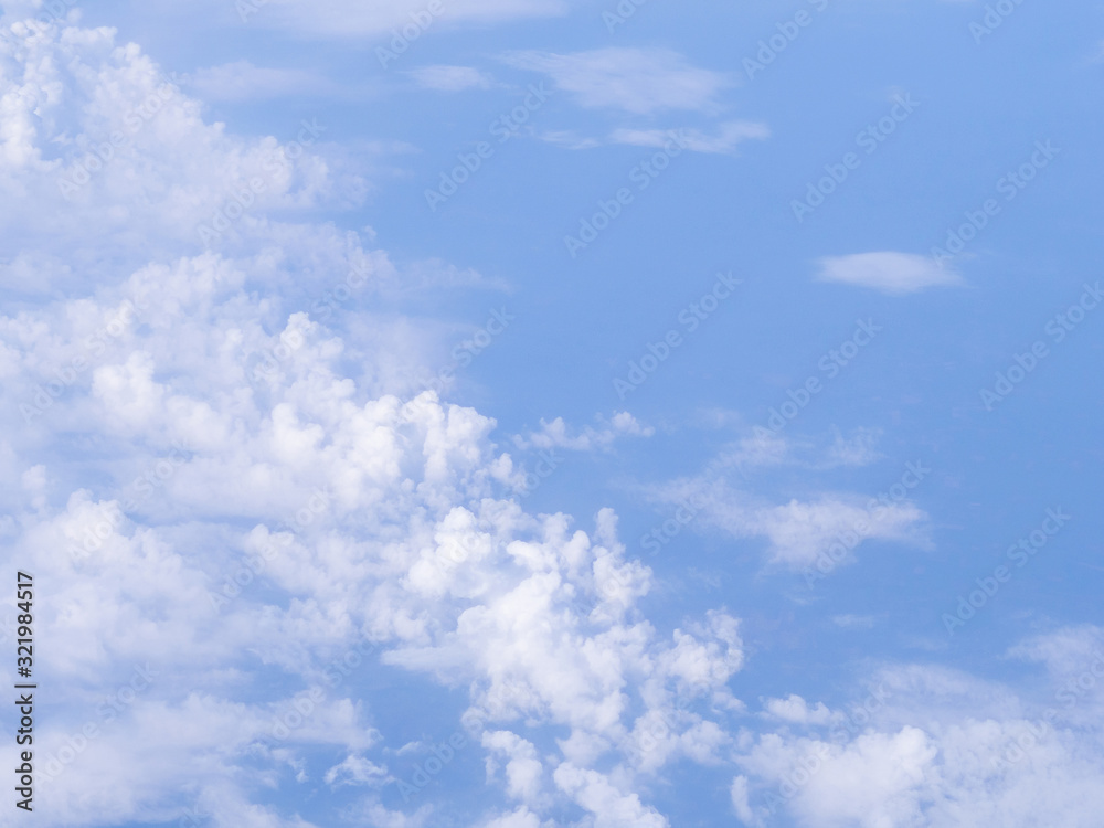 Beautiful view from airplane window above the clouds. Bright blue sky and white clouds. Skyline background with copy space. Beautiful view from airplane window above the clouds. Bright blue sky and white clouds. Skyline background with copy space.