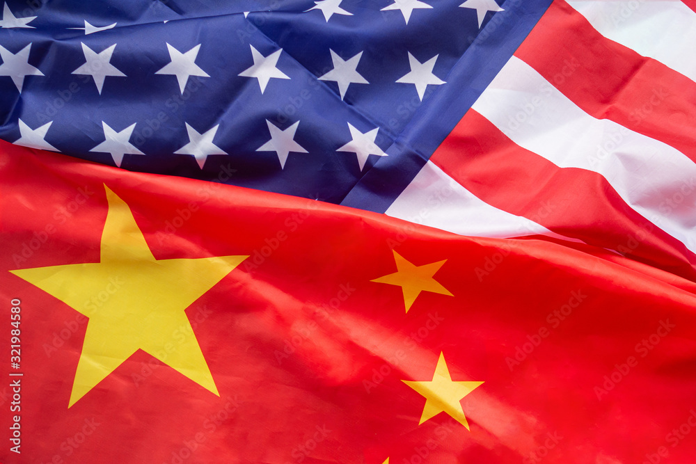 Top view of American flag and China flag together. International relationship. Trade war. Concept for Economy, connection, partnership, relationship and friendship. Top view of American flag and China flag together. International relationship. Trade war. Concept for Economy, connection, partnership, relationship and friendship.