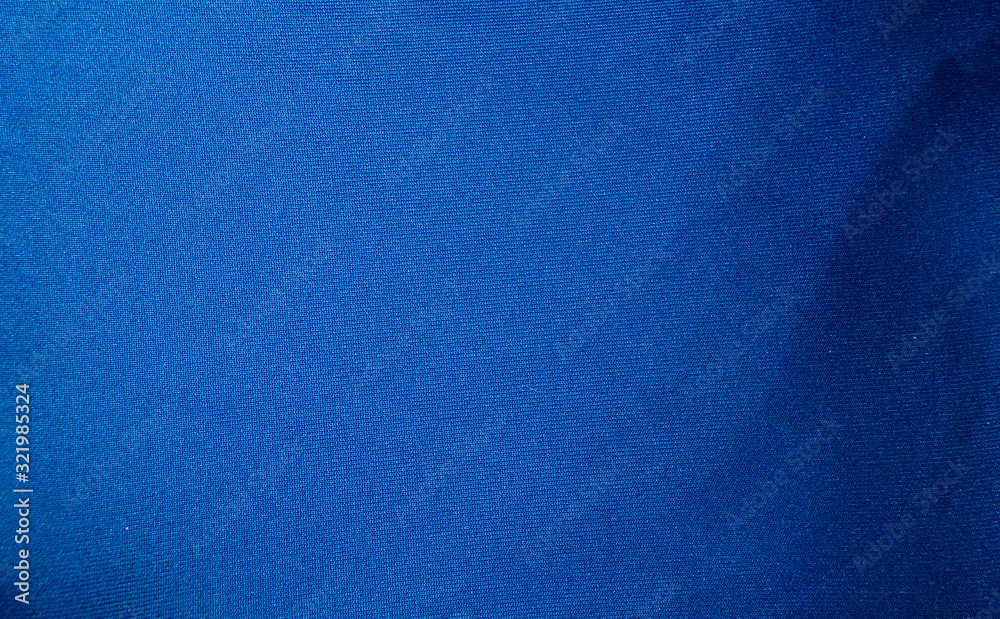 Fabric texture and background. Blue luxury fabric with curves.