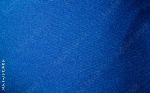 Fabric texture and background. Blue luxury fabric with curves. © Stakon
