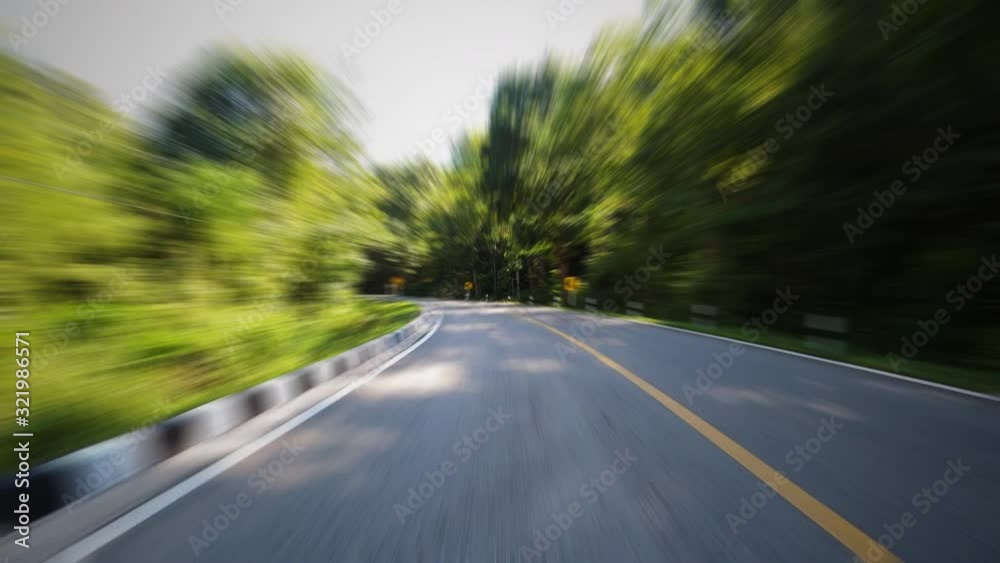 Time-lapse journey on the countryside road fast movement speed in the rural place with wood and forest with motion blur effect Time-lapse journey on the countryside road fast movement speed in the rural place with wood and forest with motion blur effect