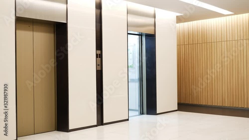 Modern steel elevator cabins in a business lobby or Hotel, Store, interior, office,perspective wide angle. Three elevators in hotel lobby.