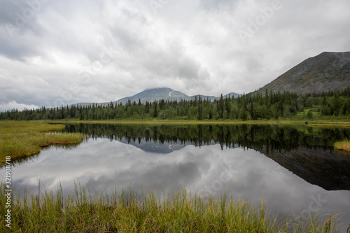 Mountain lake in the taiga. Mountains of the Subpolar Urals.