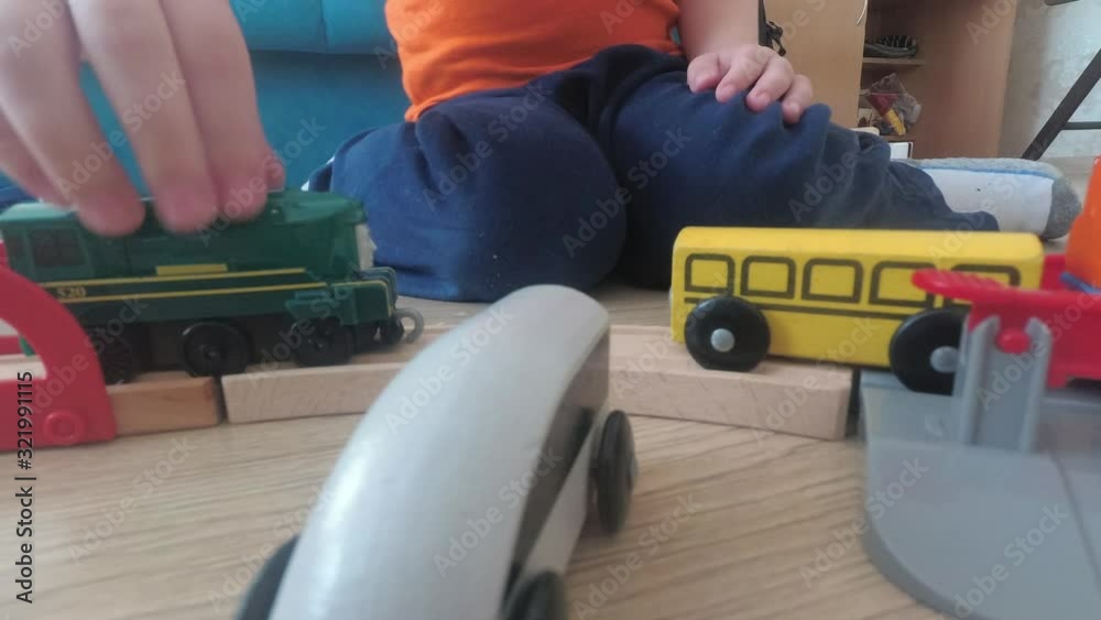 Three years old child boy play with train, build toy railroad at home. Three years old child boy play with train, build toy railroad at home.