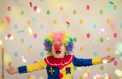 Funny kid clown playing indoor