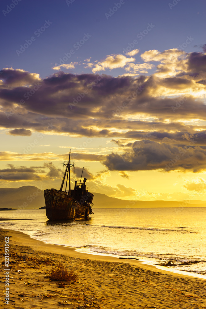 Rusty broken shipwreck on sea shore Rusty broken shipwreck on sea shore