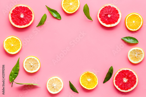 Citrus fruits - lemons  grapefruit slices - on pink background mockup  frame top-down copy space