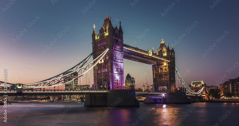 London red bus crosses Tower Bridge in London.