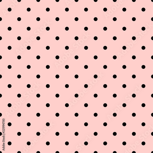 Black polka dots on a pink background.seamless Polka dot background