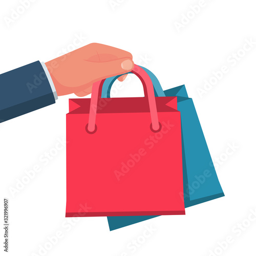 Purchases in hand. Man hold shopping. Vector illustration flat style design. Multicolored paper bags. Template for sales. Empty space for discounts and offers.