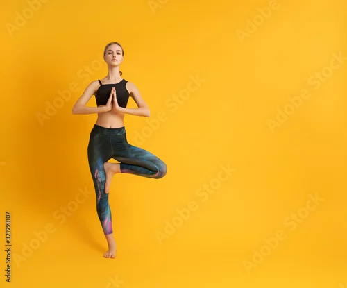 Fototapeta na wymiar Woman is practicing yoga and meditation