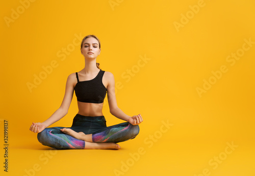 Fototapeta Naklejka Na Ścianę i Meble -  Woman is practicing yoga and meditation