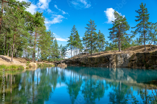 Fototapeta Naklejka Na Ścianę i Meble -  Old open pit mine with crystal clear turquoise water