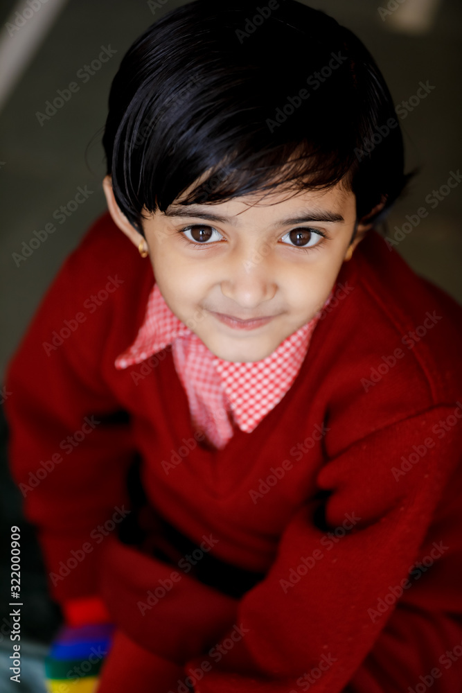 Indian little girl in school uniform and showing expression Indian little girl in school uniform and showing expression