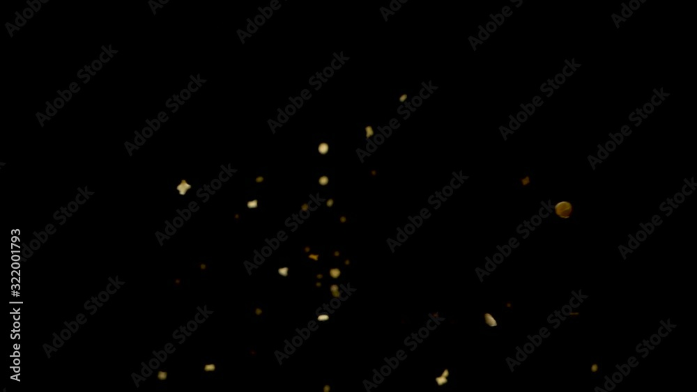 Slow motion golden confetti drops from above onto camera lens. Slow motion golden confetti drops from above onto camera lens.