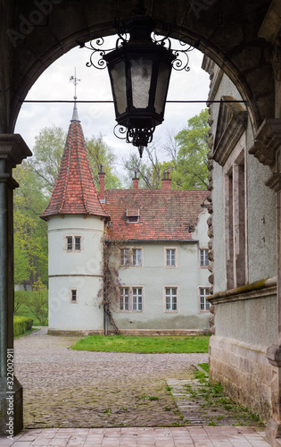 Tower of the old castle, view from under the portico photo