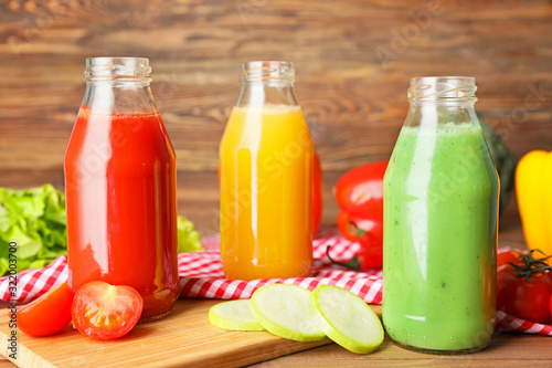 Bottles of fresh vegetable juices on table