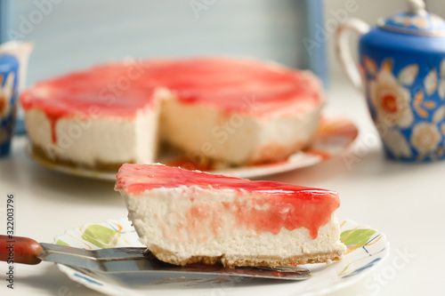 cheese cake with strawberry jam topping close up photo