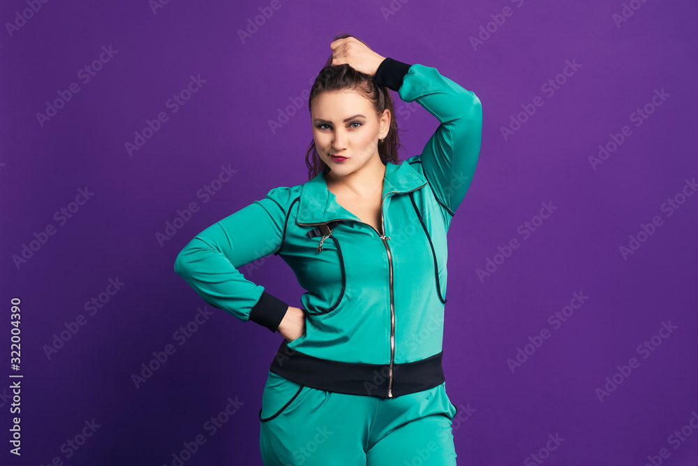 Plus size model in sportswear, fat woman on purple background Plus size model in sportswear, fat woman on purple background