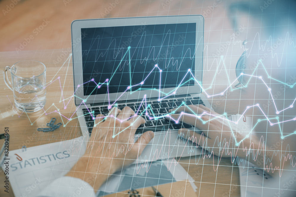 Multi exposure of market chart with man working on computer on background. Concept of financial analysis. Multi exposure of market chart with man working on computer on background. Concept of financial analysis.