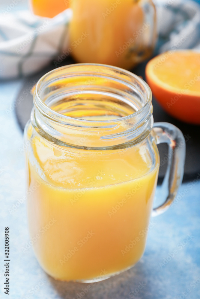 Mason jar of fresh orange juice on table Mason jar of fresh orange juice on table