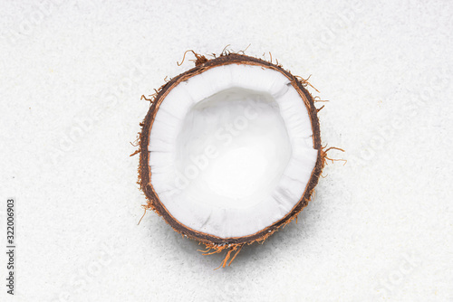Half of ripe coconut on light background