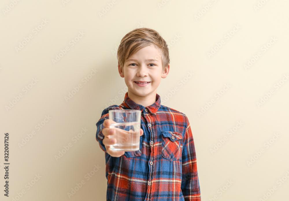 Cute little boy with glass of water on color background Cute little boy with glass of water on color background