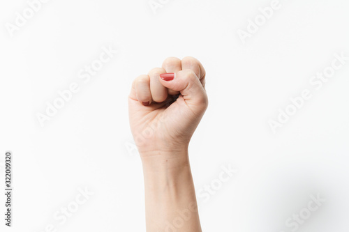 Quadro su tela Woman's hands with fist gesture on a white background