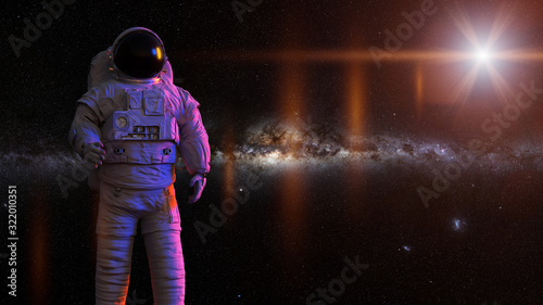 standing astronaut in front of the Milky Way galaxy