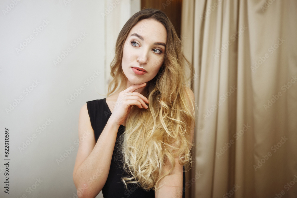 Portrait of young skinny beauty woman in the dressing room looking at the mirror Portrait of young skinny beauty woman in the dressing room looking at the mirror