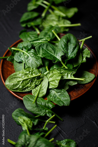 fresh spinach leaves on dark backgrownd. Top view