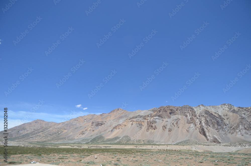 the view of Himalaya mountains on a sunny day under the blue sky in the morning or the evening in Tibet India China the road on high altitudes