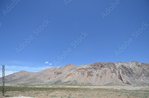 the view of Himalaya mountains on a sunny day under the blue sky in the morning or the evening in Tibet India China the road on high altitudes