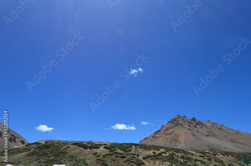 the view of Himalaya mountains on a sunny day under the blue sky in the morning or the evening in Tibet India China the road on high altitudes