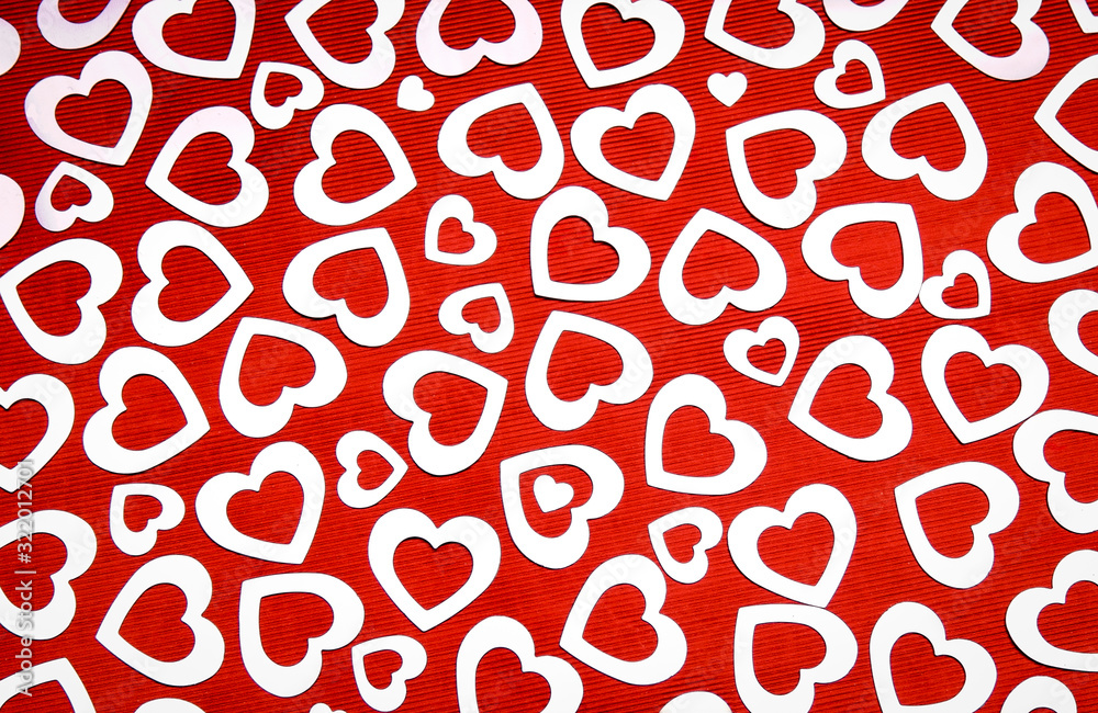 Full frame Valentine's Day background of silver hearts on a textured red background Full frame Valentine's Day background of silver hearts on a textured red background