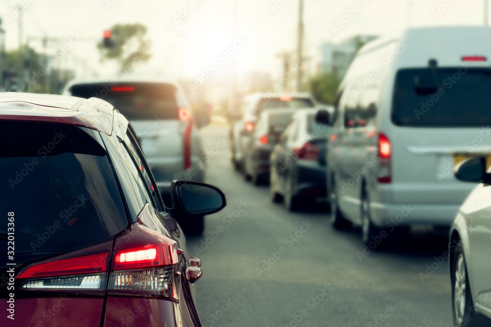 Brake of red car on asphalt roads during rush hours for travel or business work. Cars parked in a row. Brake of red car on asphalt roads during rush hours for travel or business work. Cars parked in a row.
