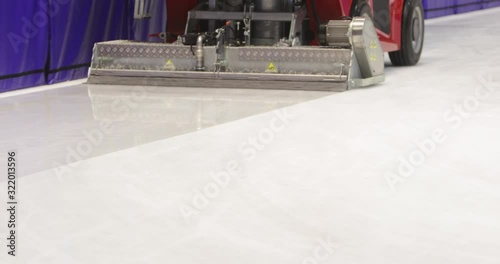 Footage of an ice-resurfacing machine polishing the rink